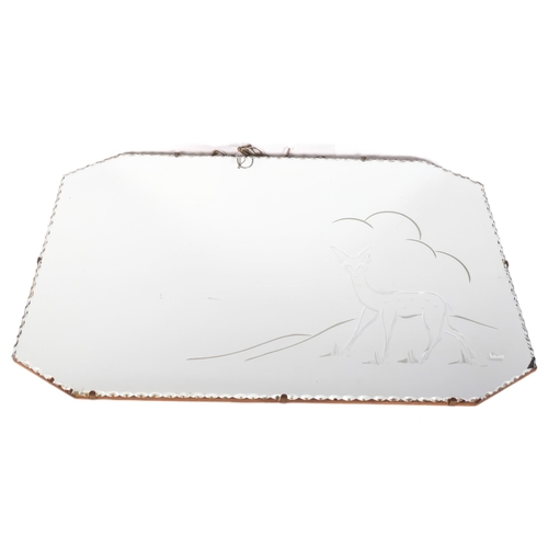 870 - A 1950s canted corner wall mirror, with scalloped edge and deer decoration, 76cm x 50cm overall