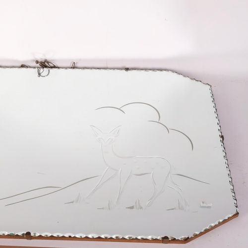 870 - A 1950s canted corner wall mirror, with scalloped edge and deer decoration, 76cm x 50cm overall