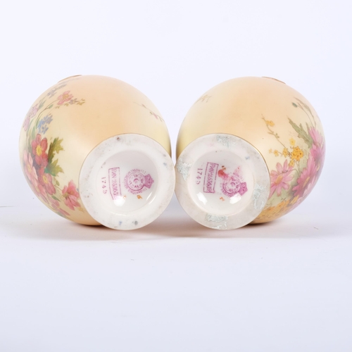 886 - A pair of Royal Worcester Blush Ivory ewers, decorated with sprays of flowers, shape no. 1745, decor... 