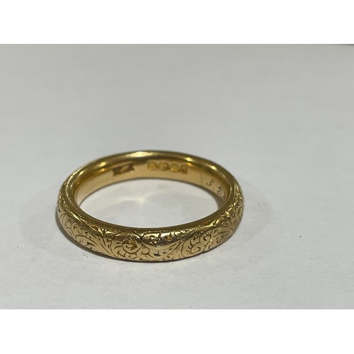 1212 - A heavy early 20th century 18ct gold wedding band ring, maker WJP, London 1913, with engraved foliat... 