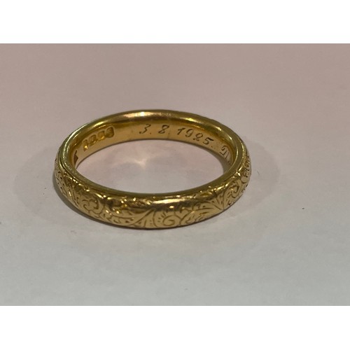 1212 - A heavy early 20th century 18ct gold wedding band ring, maker WJP, London 1913, with engraved foliat... 