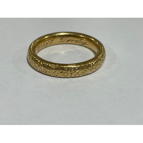 1212 - A heavy early 20th century 18ct gold wedding band ring, maker WJP, London 1913, with engraved foliat... 