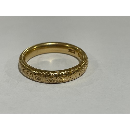 1212 - A heavy early 20th century 18ct gold wedding band ring, maker WJP, London 1913, with engraved foliat... 