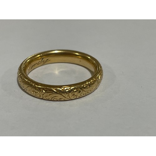 1212 - A heavy early 20th century 18ct gold wedding band ring, maker WJP, London 1913, with engraved foliat... 