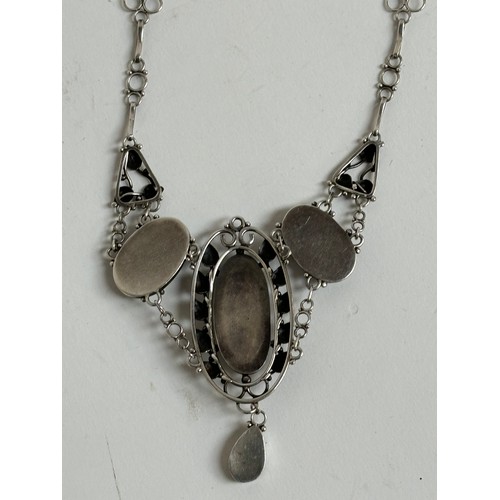 1201 - A stylised unmarked white metal pendant necklace, set with 4 oval pearl panels