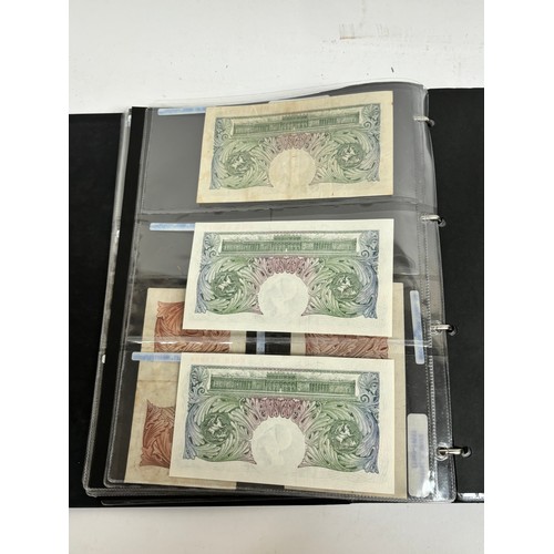 331 - An album of United Kingdom banknotes, including 2 white £5 notes, £1 notes from circa 1930, 1940, 19... 