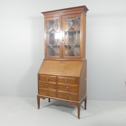 2103 - A reproduction mahogany two-section bureau bookcase, with lattice glazed doors, a fall-front reveali... 