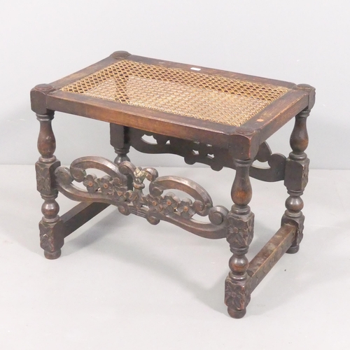 2106 - An antique oak stool, with cane seat and carved decoration. 55x45x38cm.