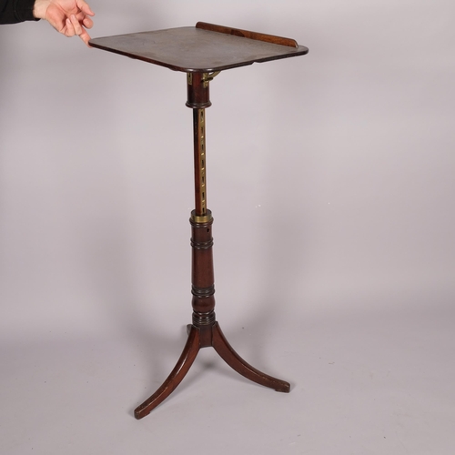 104 - A George III mahogany reading table, with rise and fall tilt top, brass adjusting mechanism and trip... 