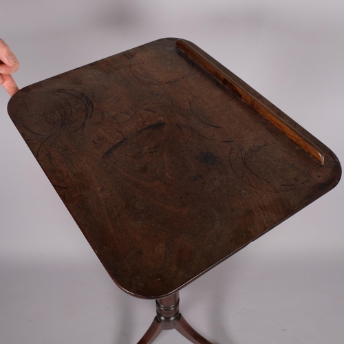 104 - A George III mahogany reading table, with rise and fall tilt top, brass adjusting mechanism and trip... 