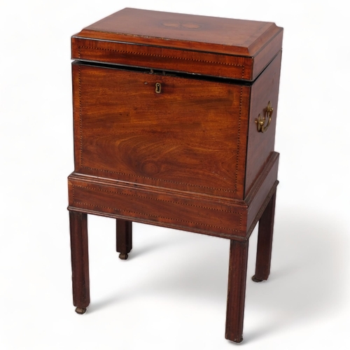 106 - George III mahogany cellarette, the inlaid top having a concave edge, brass carrying handles and div... 