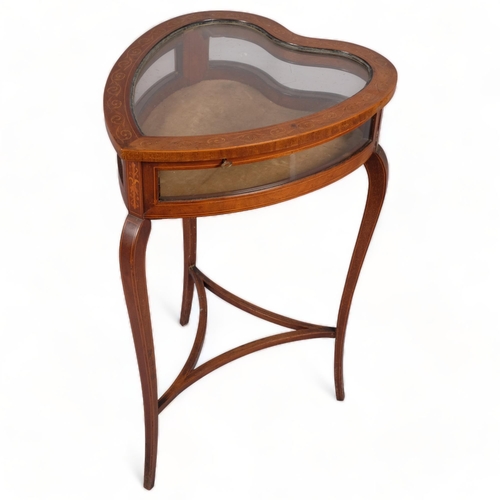 107 - An Edwardian mahogany heart-shaped vitrine table, with inlaid scroll marquetry, curved glass side pa... 