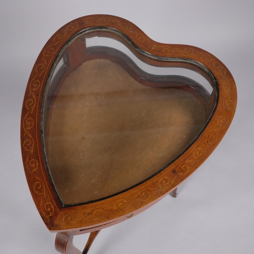 107 - An Edwardian mahogany heart-shaped vitrine table, with inlaid scroll marquetry, curved glass side pa... 