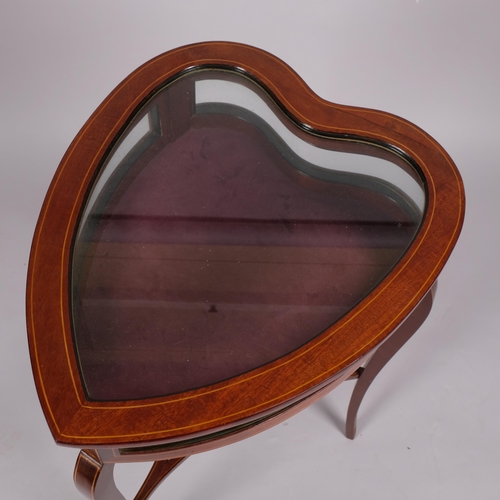 108 - An Edwardian mahogany heart-shaped vitrine table, with inlaid stringing, curved side panels, on shap... 