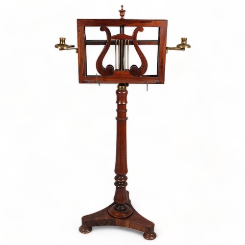 117 - A 19th century rosewood duet music stand, with brass candle brackets, adjustable column and platform... 