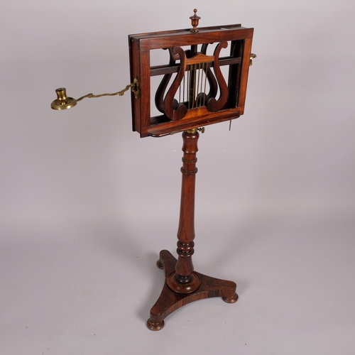 117 - A 19th century rosewood duet music stand, with brass candle brackets, adjustable column and platform... 