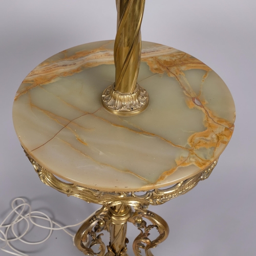 124 - A 19th century gilt-brass standard lamp with onyx table section, on acanthus tripod base, converted ... 