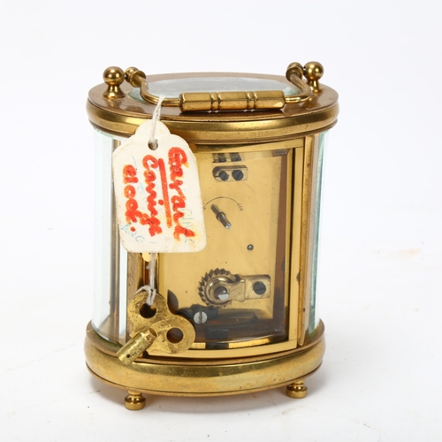 129 - GARRARD - an oval brass-cased carriage clock, case height 11.5cm