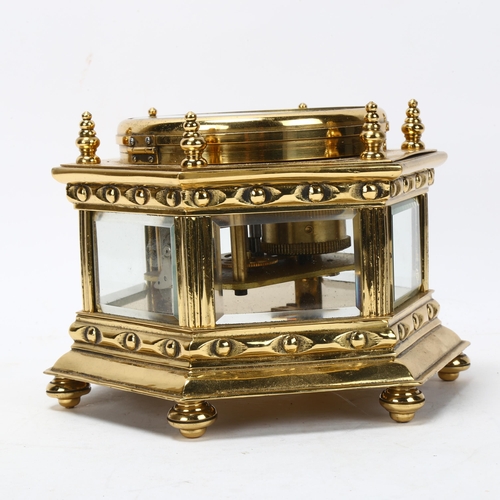 130 - An octagonal brass-cased table clock, probably mid-20th century, with enamel dial and 8-day movement... 