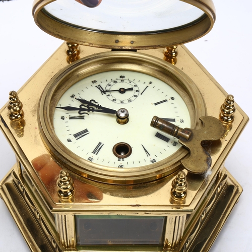 130 - An octagonal brass-cased table clock, probably mid-20th century, with enamel dial and 8-day movement... 