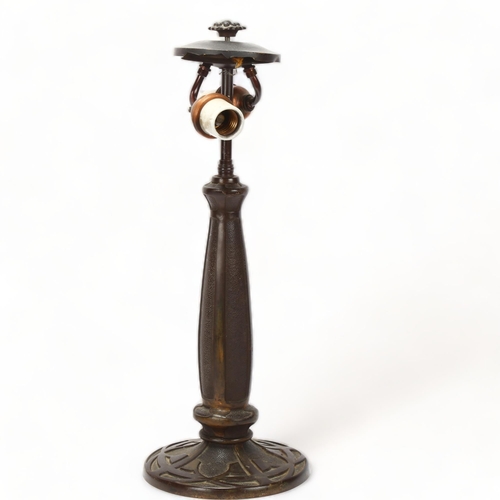 189 - An early 20th century relief cast bronze table lamp in the manner of Tiffany, no factory marks, over... 