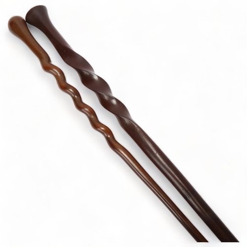 192 - An African hardwood spiral twist ceremonial staff, and a similar hardwood twist design stick (2)