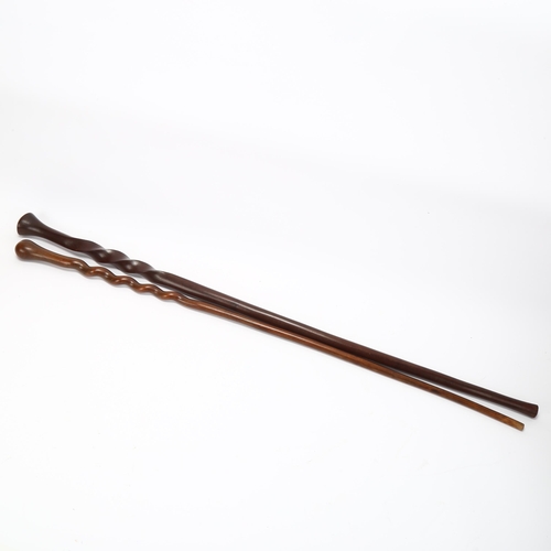 192 - An African hardwood spiral twist ceremonial staff, and a similar hardwood twist design stick (2)