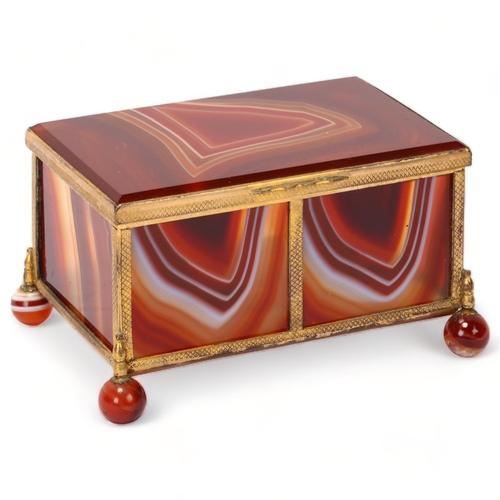 196 - A large 19th century polished agate and gilt-metal casket, on agate ball feet, 11cm x 7cm x 7cm