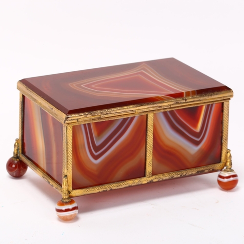 196 - A large 19th century polished agate and gilt-metal casket, on agate ball feet, 11cm x 7cm x 7cm