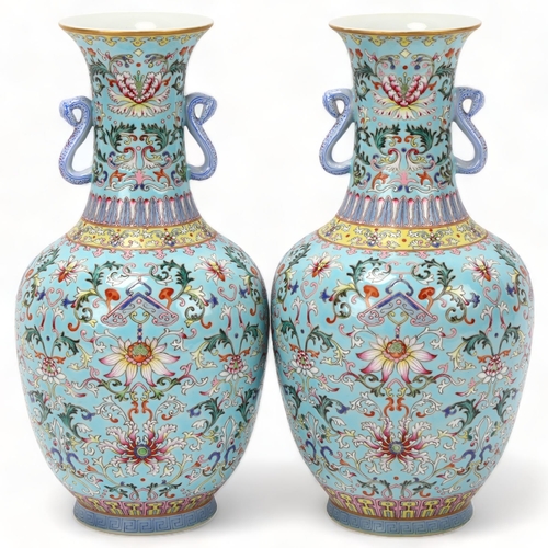 215 - Pair of Chinese pale blue glaze porcelain vases with rui design handles, allover painted enamel flor... 