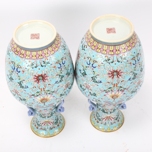 215 - Pair of Chinese pale blue glaze porcelain vases with rui design handles, allover painted enamel flor... 