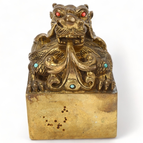 225 - A Chinese solid cast gilt-bronze dragon design desk seal, set with turquoise and coral, height 12.5c... 