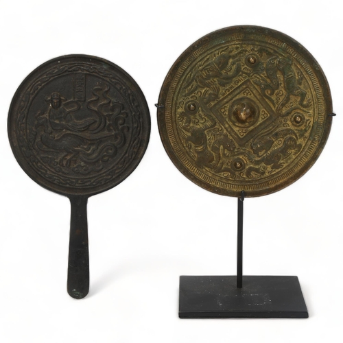 228 - A Chinese relief cast patinated bronze mirror, with gilded dragon decoration, diameter 12cm, and a C... 