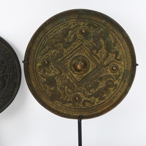 228 - A Chinese relief cast patinated bronze mirror, with gilded dragon decoration, diameter 12cm, and a C... 