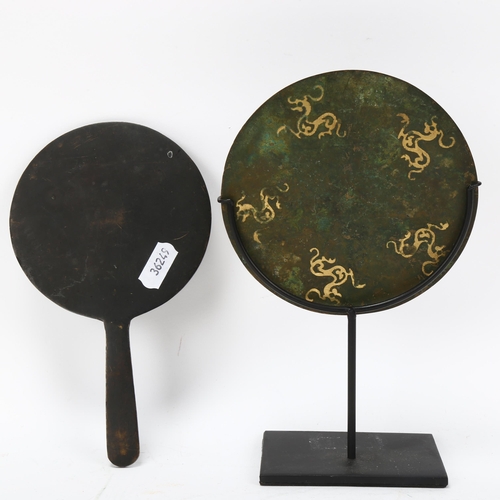 228 - A Chinese relief cast patinated bronze mirror, with gilded dragon decoration, diameter 12cm, and a C... 