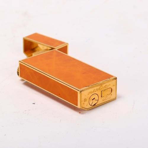 256 - MUST DE CARTIER - Briquet pocket lighter, gilt-metal with orange lacquer, length 6cm, boxed with pap... 