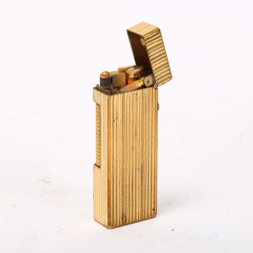 258 - DUNHILL - gold plated pocket lighter, length 62mm, boxed with papers