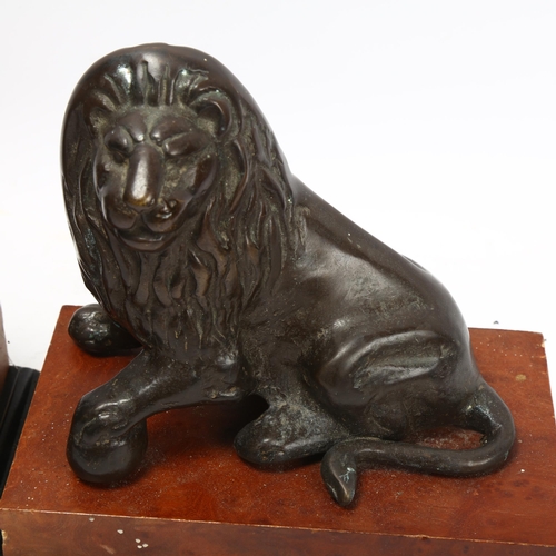 343 - Pair of 20th century patinated bronze lions on stained wood bases, base length 20cm, height 18cm