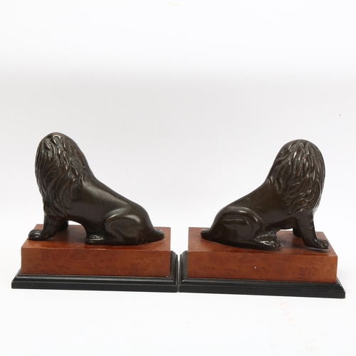 343 - Pair of 20th century patinated bronze lions on stained wood bases, base length 20cm, height 18cm