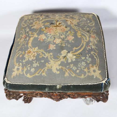 351 - A large Victorian carved oak-framed stool, on elaborate base with lion paw feet, approx 70cm square