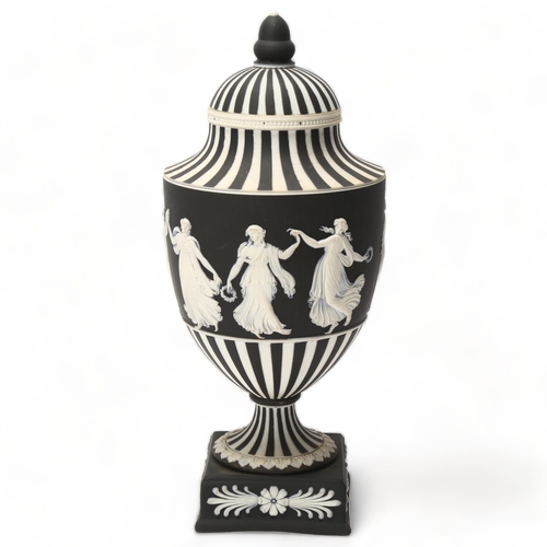 68 - Wedgwood black and white Jasper urn and cover, decorated with dancing maidens, height 25cm