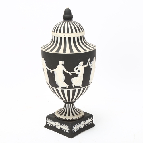 68 - Wedgwood black and white Jasper urn and cover, decorated with dancing maidens, height 25cm