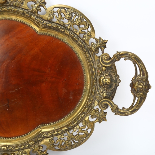 74 - 19th century cast-brass framed 2-handled tray, with inset mahogany panel in pierced and shaped surro... 