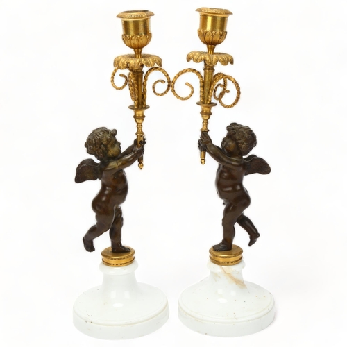 76 - Pair of 19th century parcel-gilt bronze candlesticks, supported by cherubs on white ceramic bases, h... 