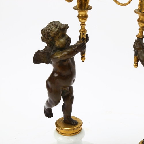 76 - Pair of 19th century parcel-gilt bronze candlesticks, supported by cherubs on white ceramic bases, h... 