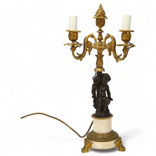 77 - 19th century parcel-gilt bronze twin-branch lamp, supported by a putto figure, on bronze-mounted ala... 