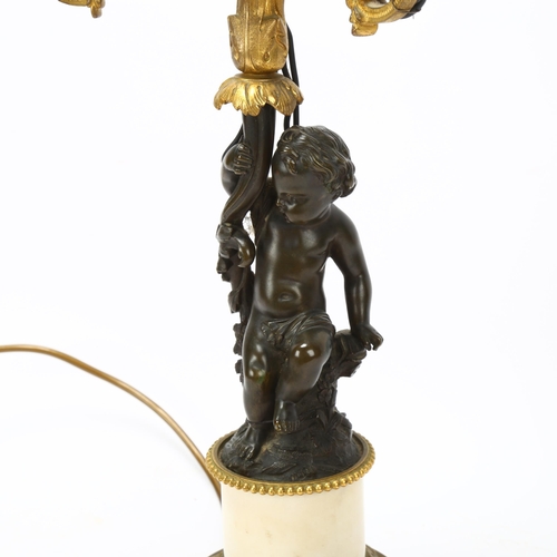 77 - 19th century parcel-gilt bronze twin-branch lamp, supported by a putto figure, on bronze-mounted ala... 