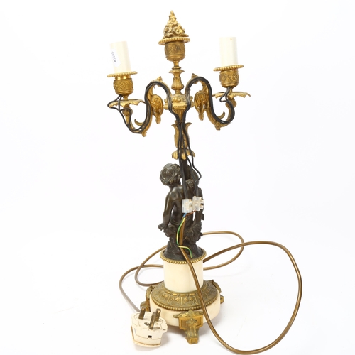 77 - 19th century parcel-gilt bronze twin-branch lamp, supported by a putto figure, on bronze-mounted ala... 