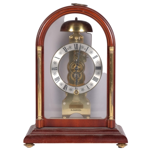 144 - A modern Hermle mahogany-cased dome-top mantel clock with brass columns, movement striking on a bell... 