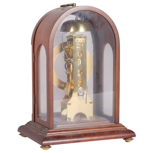 144 - A modern Hermle mahogany-cased dome-top mantel clock with brass columns, movement striking on a bell... 